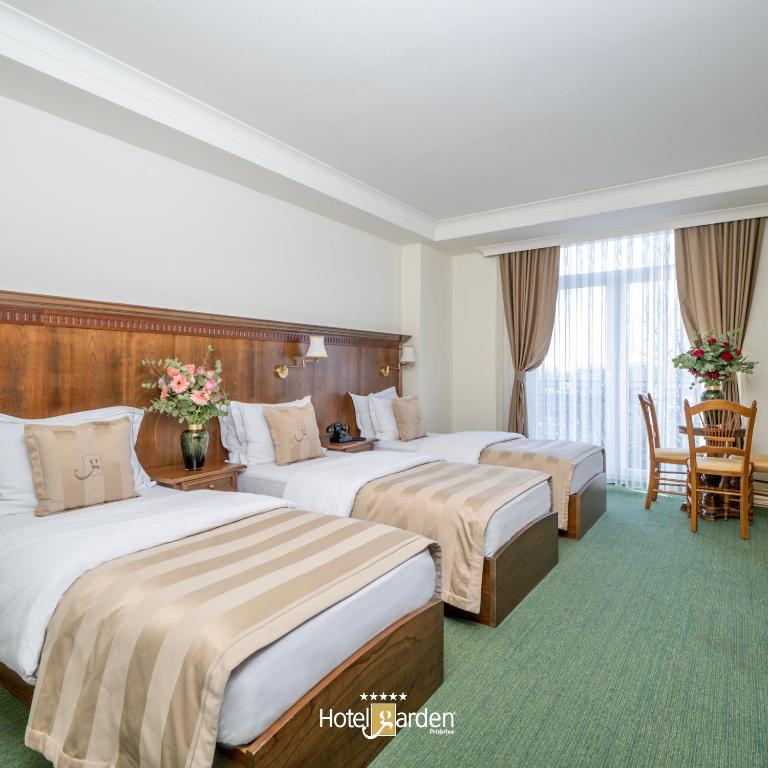 Postel nebo postele na pokoji v ubytování Hotel Garden