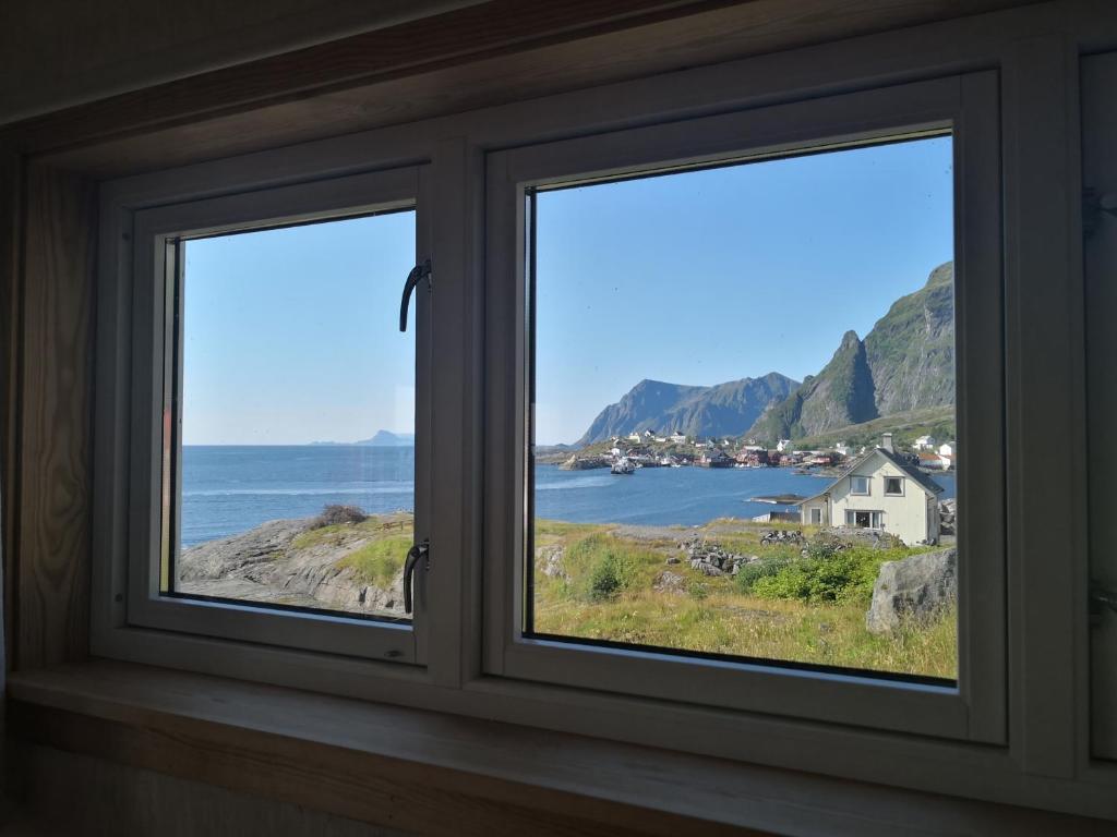 a window with a view of the ocean at House with amazing view & location in Tind in Sørvågen