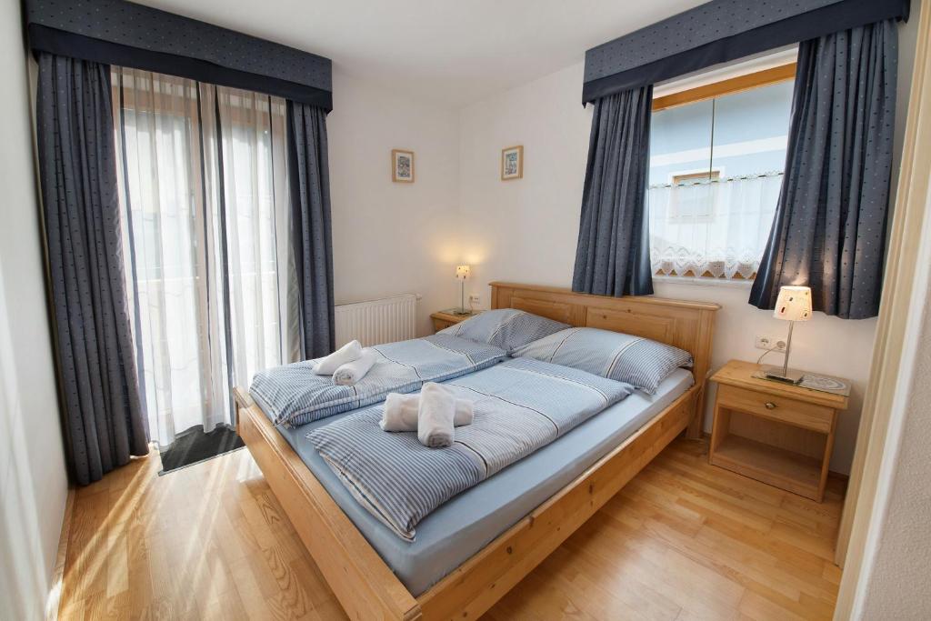 a bedroom with a bed with two towels on it at Haus Lowe Appartement 1 Stock Nr 3 in Filzmoos