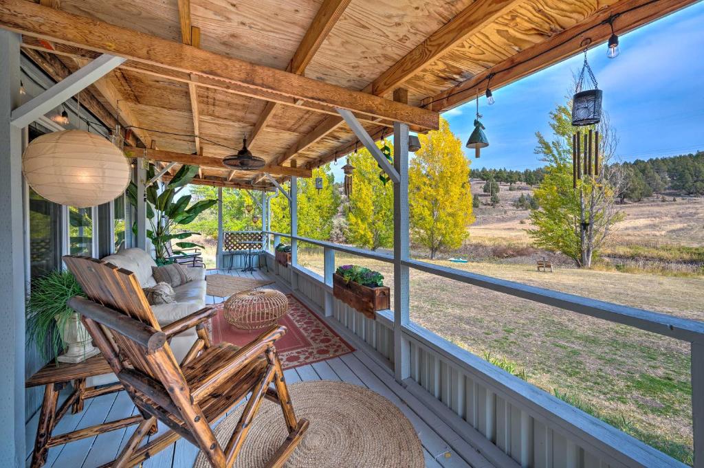 a porch with a chair and a view of a field at John Day Lakehouse with a Great Outdoor Space! in John Day