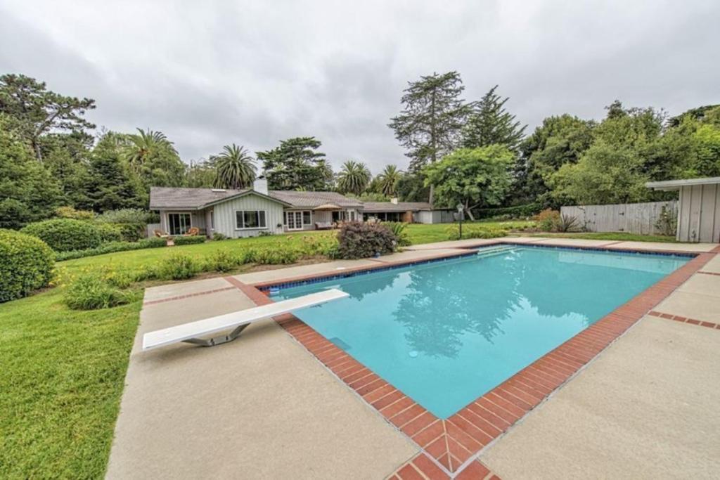 a swimming pool in front of a house at Exclusive Hope Ranch Home w/Pool and Private Beach access in Santa Barbara