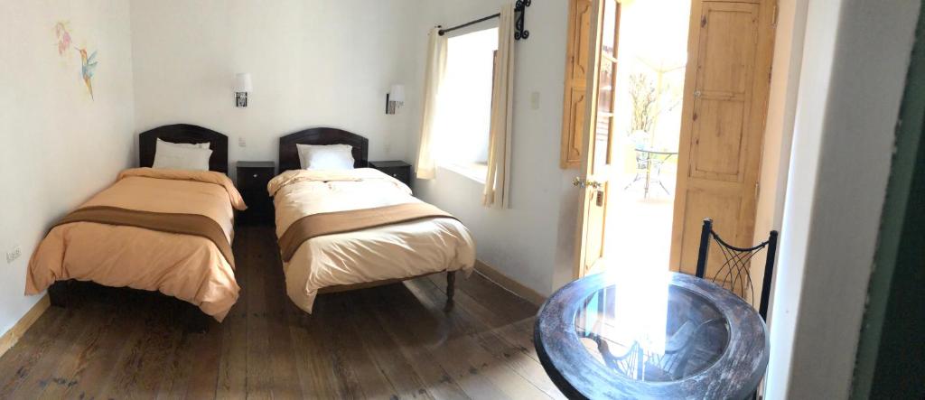 Postel nebo postele na pokoji v ubytování Hostal Qorichaska