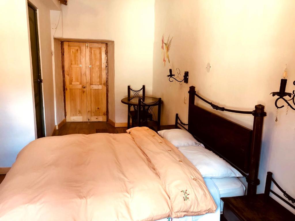 Postel nebo postele na pokoji v ubytování Hostal Qorichaska