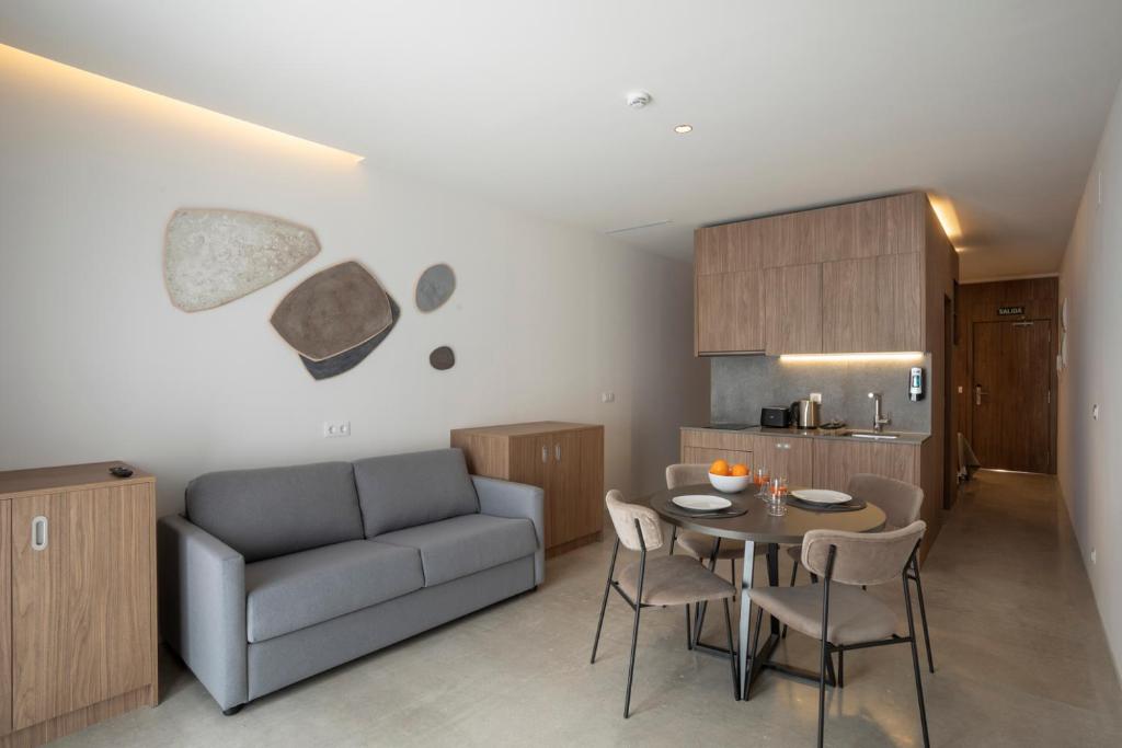 a living room with a couch and a table and chairs at Dau Studios in Valencia