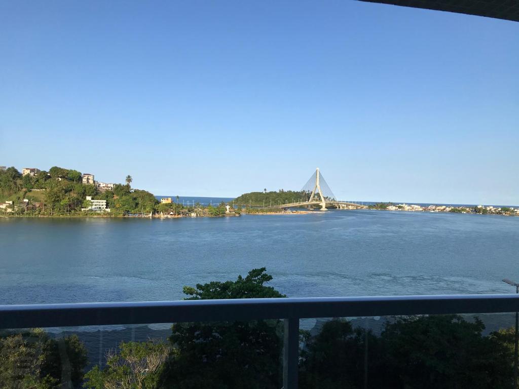 a view of a river with a bridge in the background at Vista Mar Premium in Ilhéus