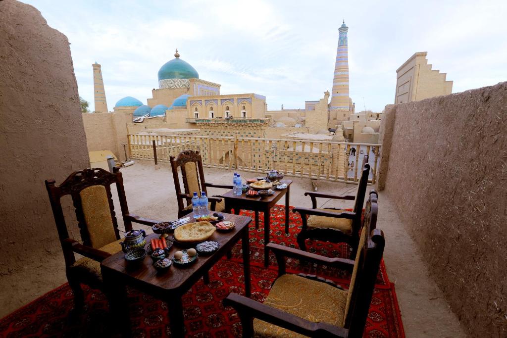a table and chairs with a view of a city at Polvonnazir Guest House in Khiva