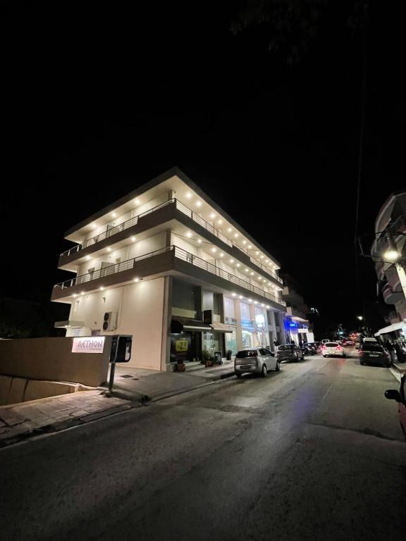 a building on the side of a street at night at Aethon Airport Project-FREE SHUTTLE in Markopoulo