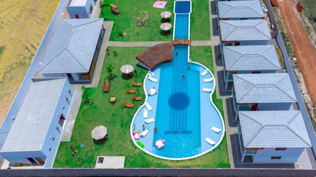 an aerial view of a house with a swimming pool at Pousada Sol e Violão in São Miguel do Gostoso