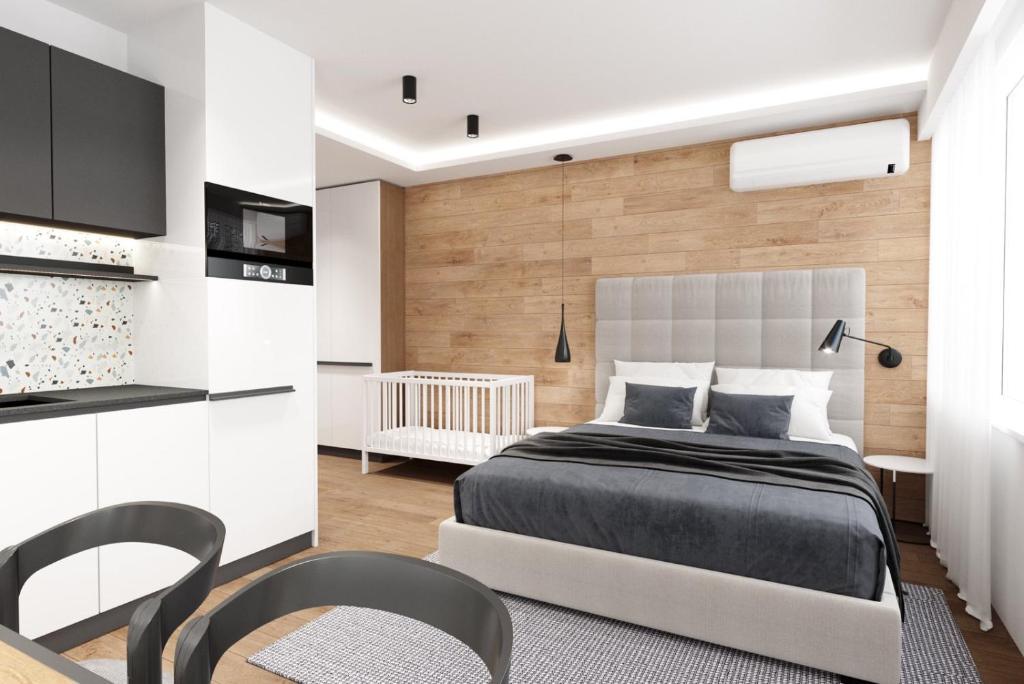 a bedroom with a bed and a table and chairs at LUXURIOUS ONE BEDROOM STUDIO IN TOP CENTER in Blagoevgrad