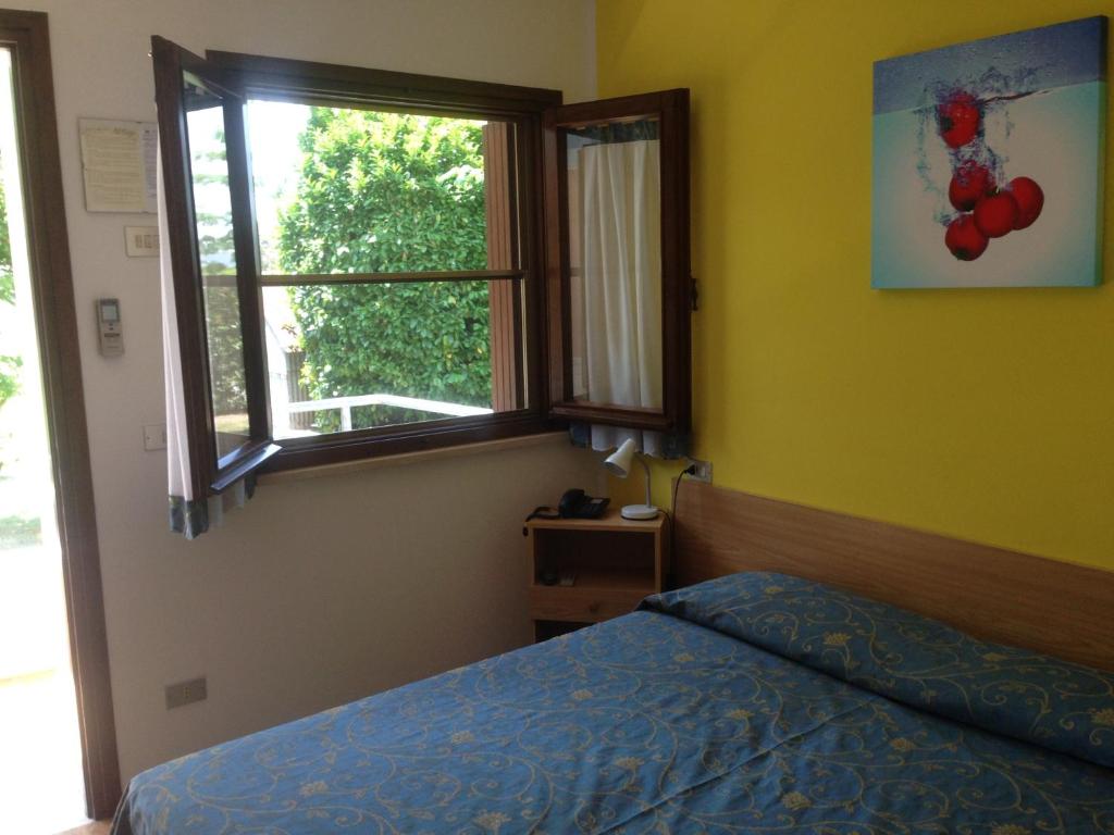Postel nebo postele na pokoji v ubytování Hotel Al Fogo