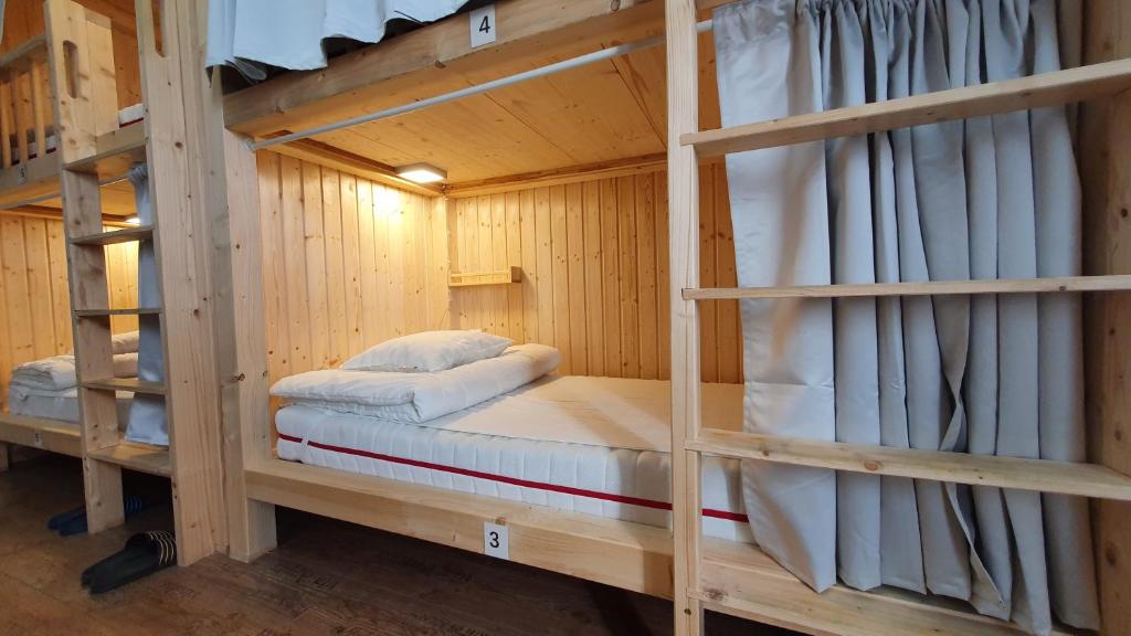 a couple of bunk beds in a wooden room at 7brunnen Hostel Beds & Rooms in Vienna