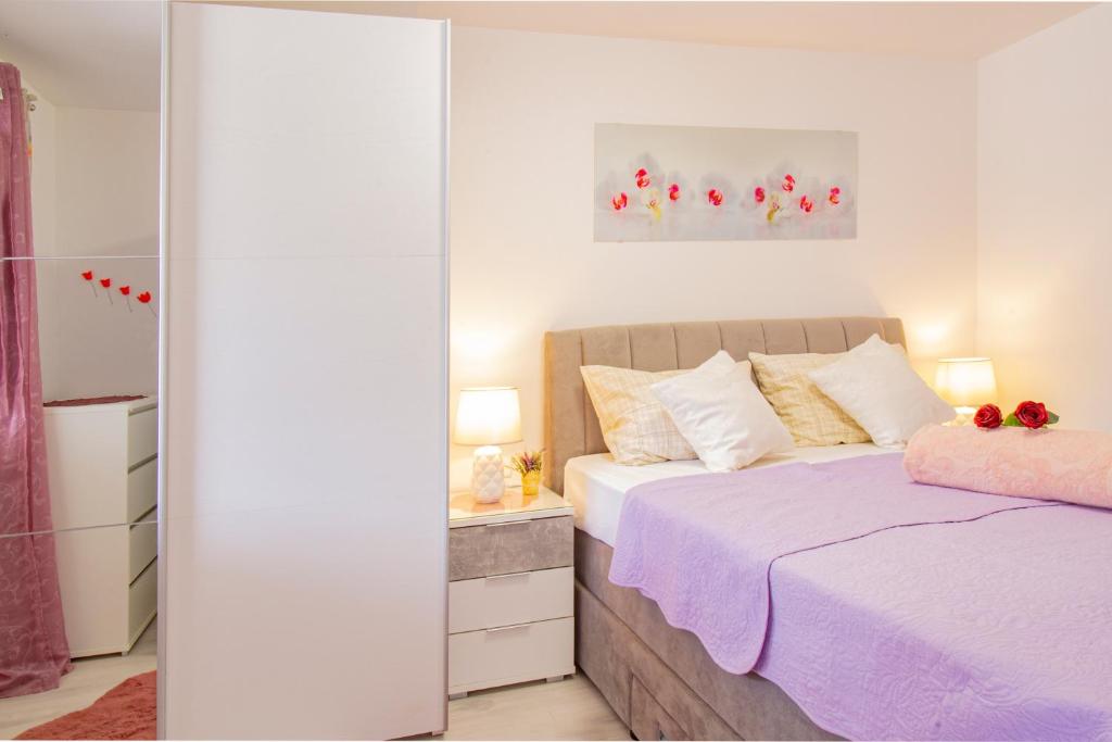 a bedroom with a bed and a mirror at Toncica Sunny terrace with seaview and shaded BBQ area in Metajna