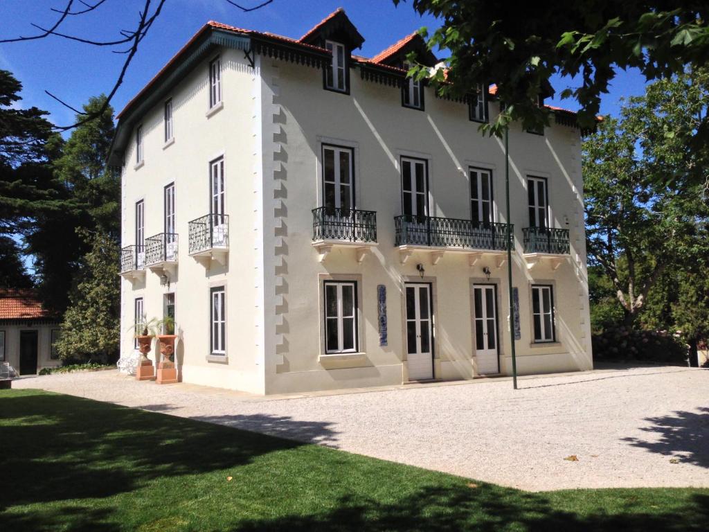 a large white building with a balcony at Luxurious royal estate in historic Sintra paradise in Sintra