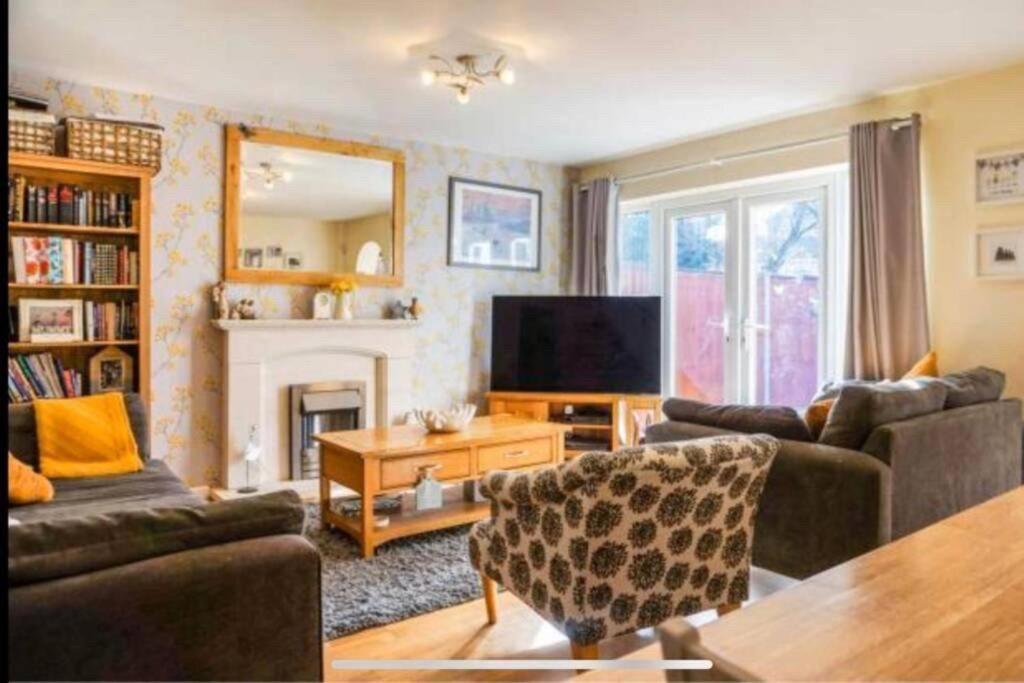 a living room with two couches and a television at Large 4 Bedroom House in Central Coventry in Walsgrave on Sowe