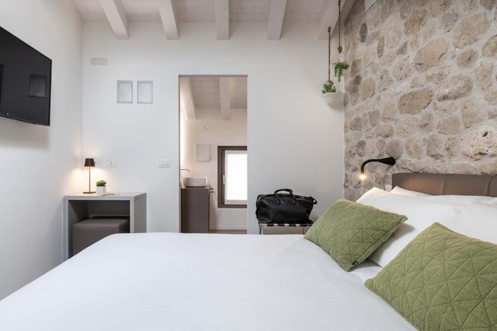 A bed or beds in a room at Portone180 Guest House