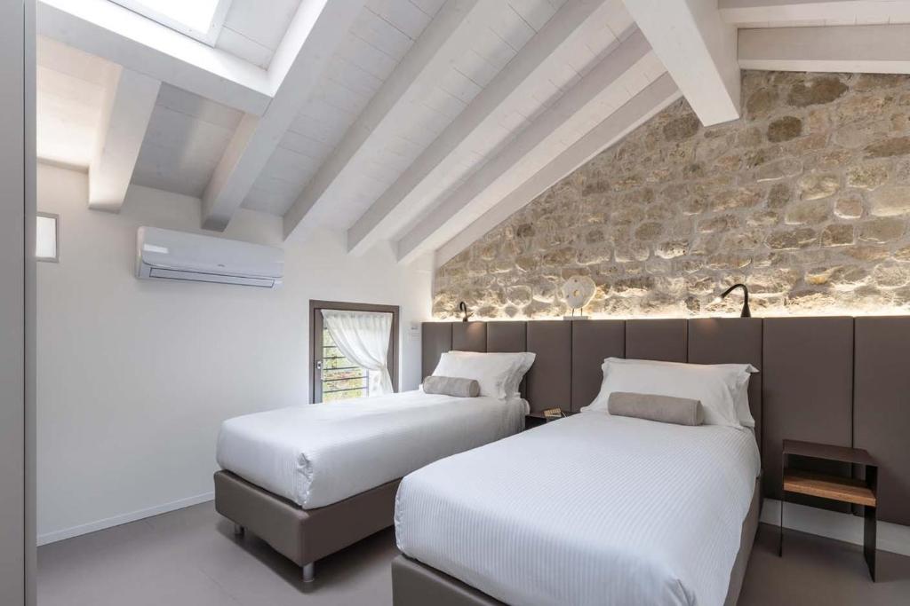 A bed or beds in a room at Portone180 Guest House