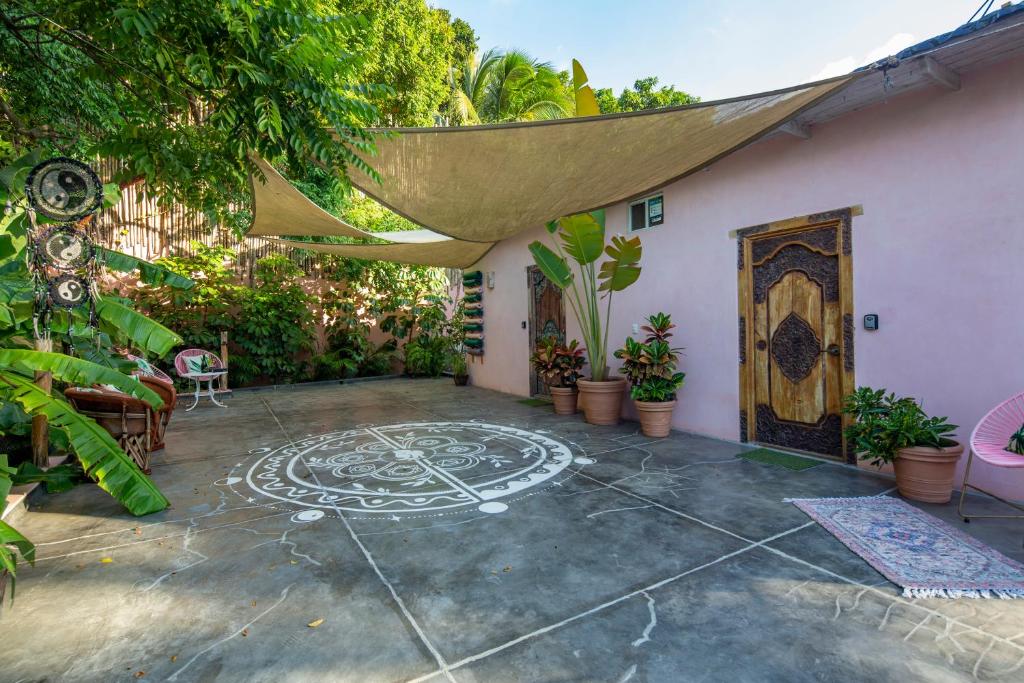 a patio with a stone design on the ground at My Sisters House - Female only in Sayulita