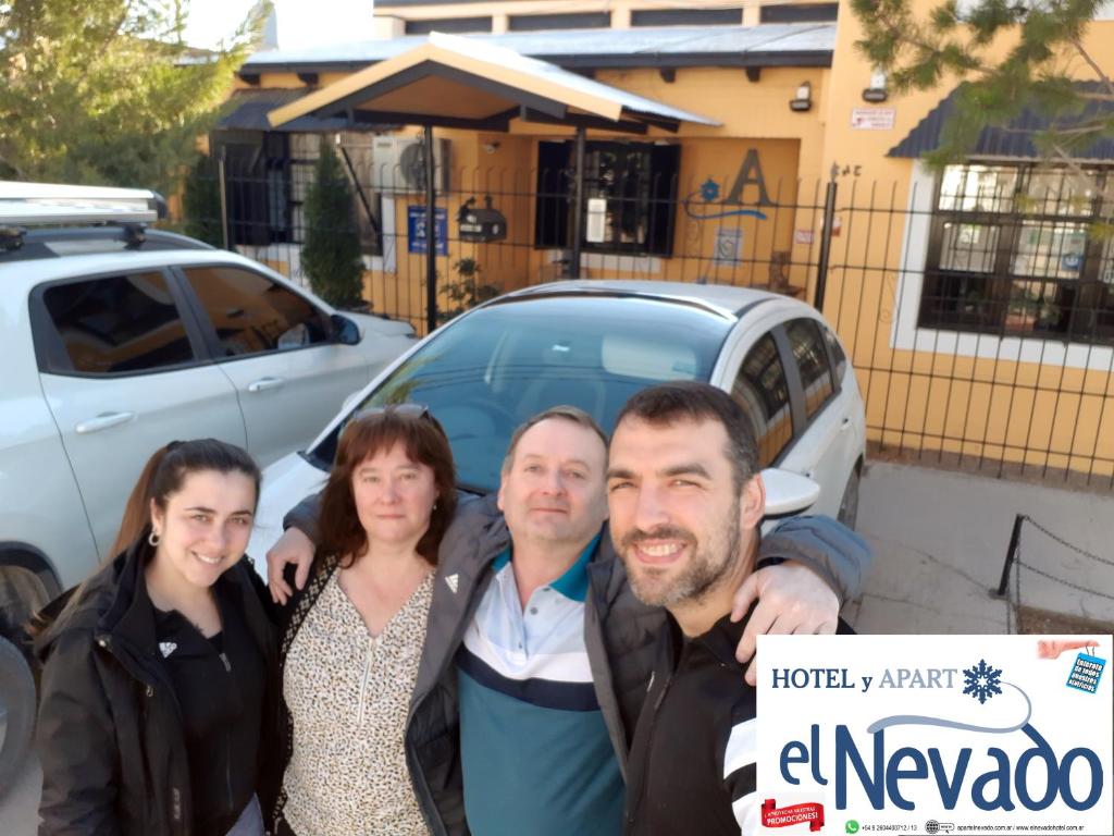 a group of people holding a sign in front of a car at Apart El Nevado Malargüe in Malargüe