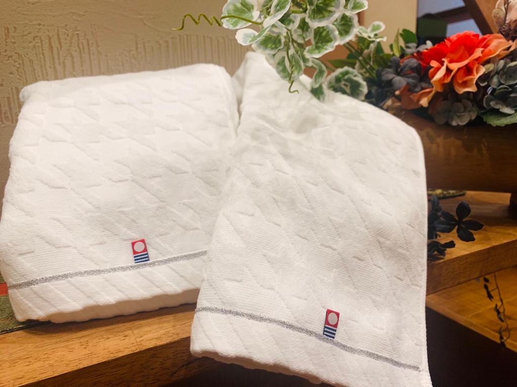 Postel nebo postele na pokoji v ubytování Ixyz別邸 月夜見の宿