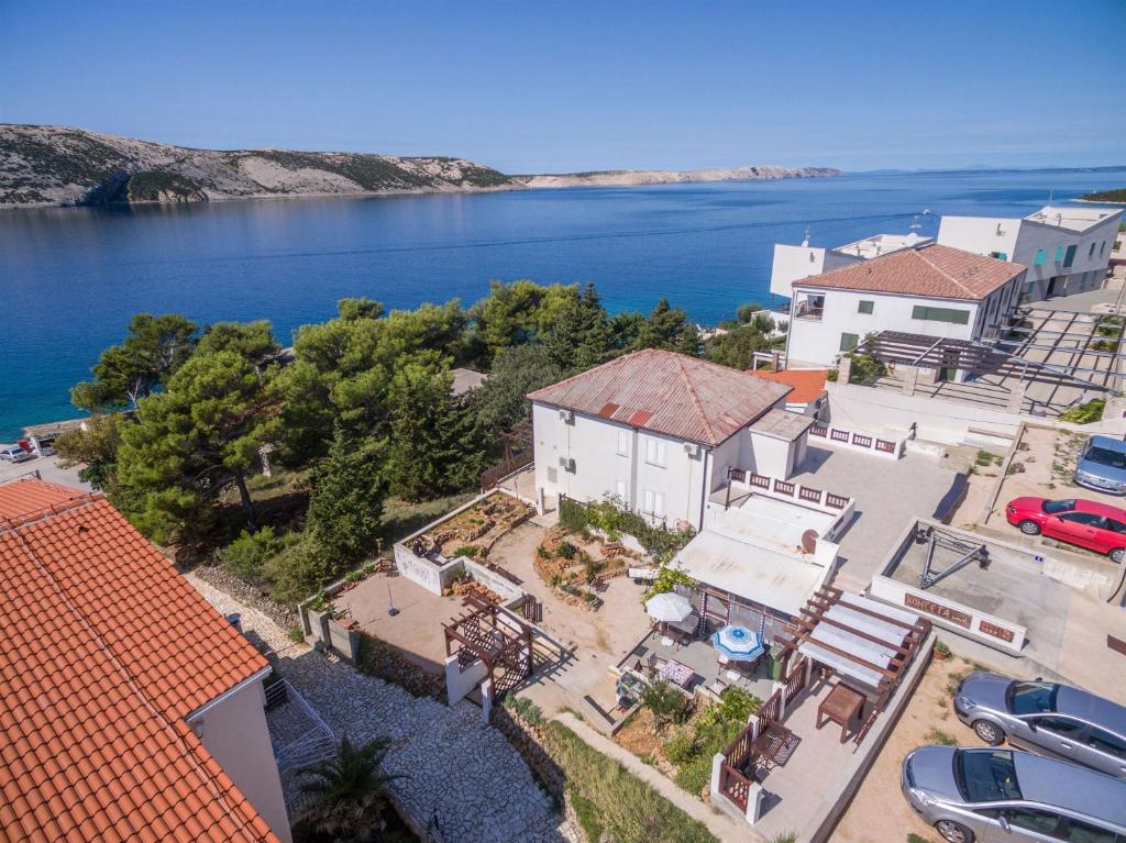 an aerial view of a house next to the water at Rooms Zdravko in Stara Novalja