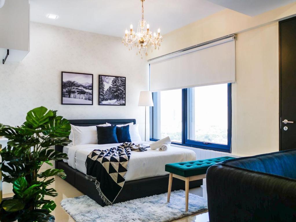 a bedroom with a bed and a chandelier at Tropicana 218 Macalister Studio with Seaview in George Town