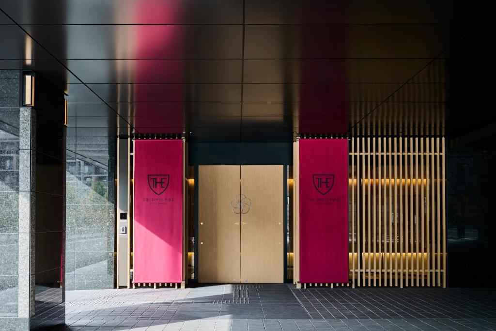 two pink doors on the side of a building at The Royal Park Hotel Kyoto Umekoji in Kyoto
