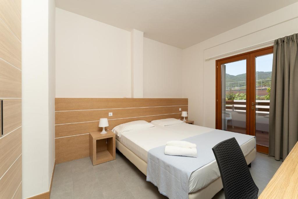 Postel nebo postele na pokoji v ubytování Hotel Delfino
