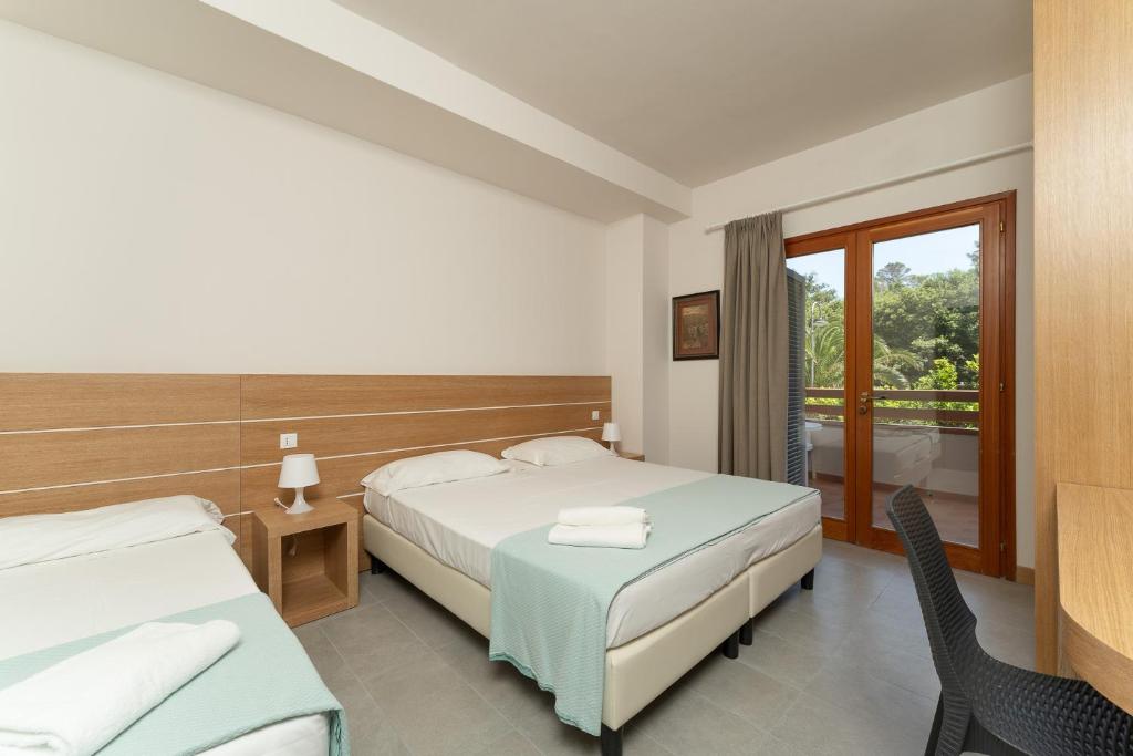 Postel nebo postele na pokoji v ubytování Hotel Delfino