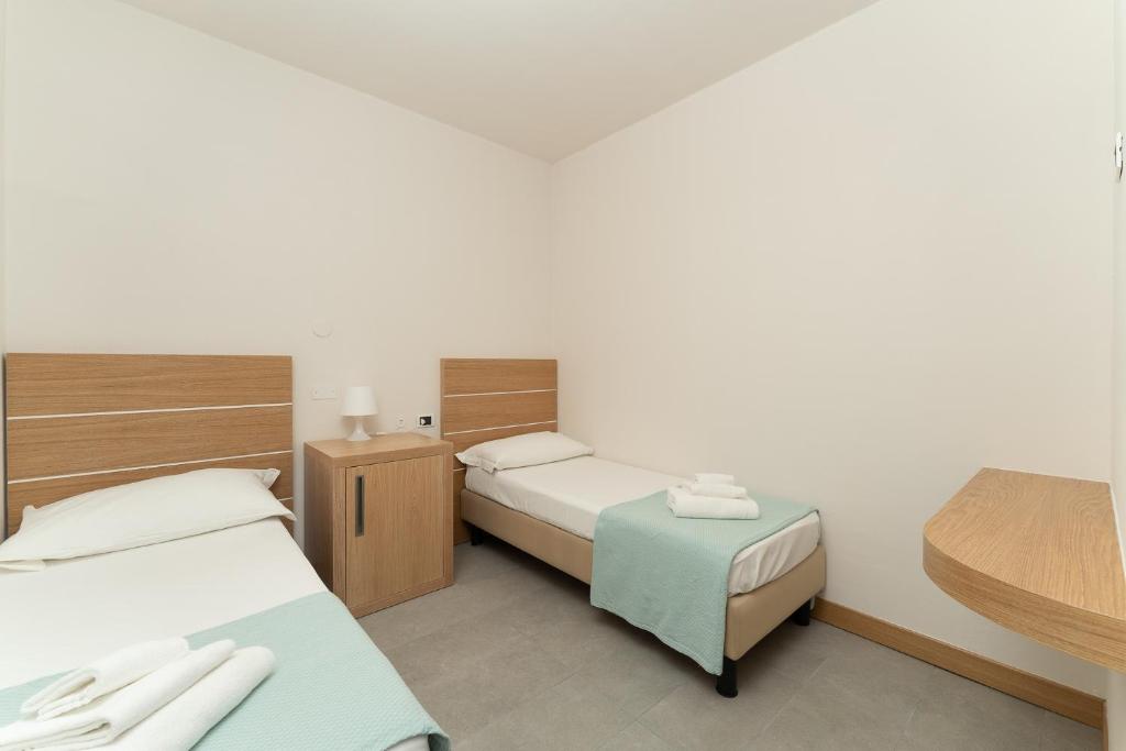 Postel nebo postele na pokoji v ubytování Hotel Delfino
