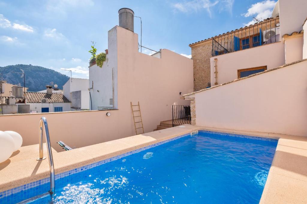 a swimming pool on the roof of a house at Townhouse Can Neri by SunVillas Mallorca in Pollença