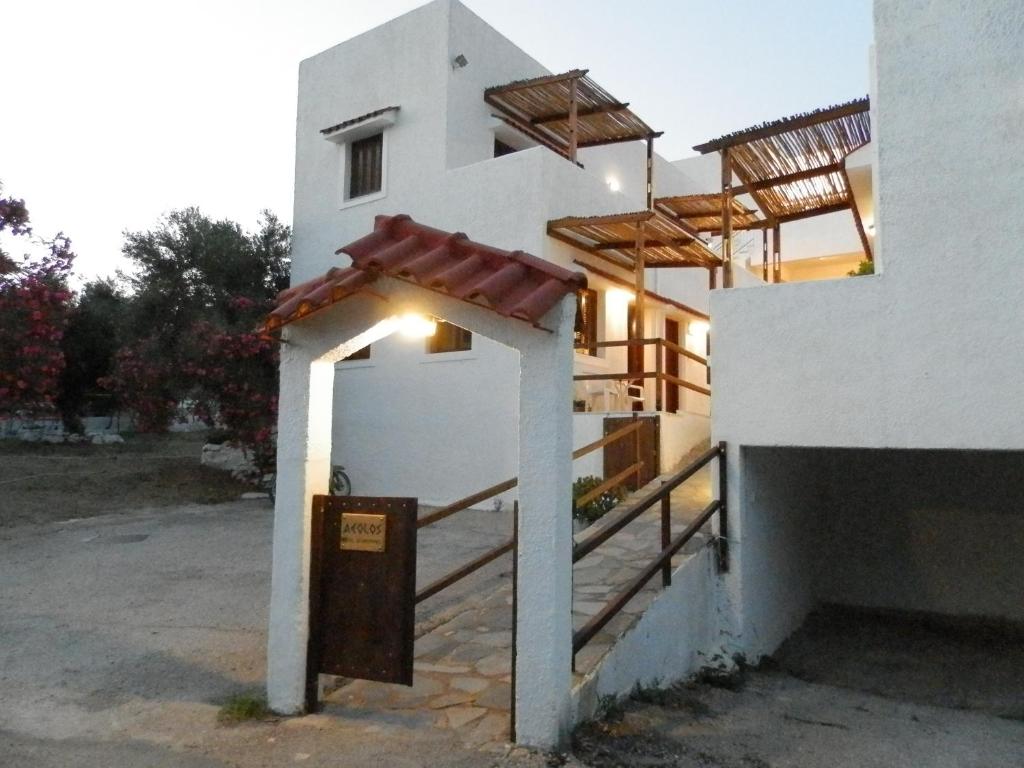 a white building with a entrance with a sign on it at Aeolos Hotel Apartments in Gythio