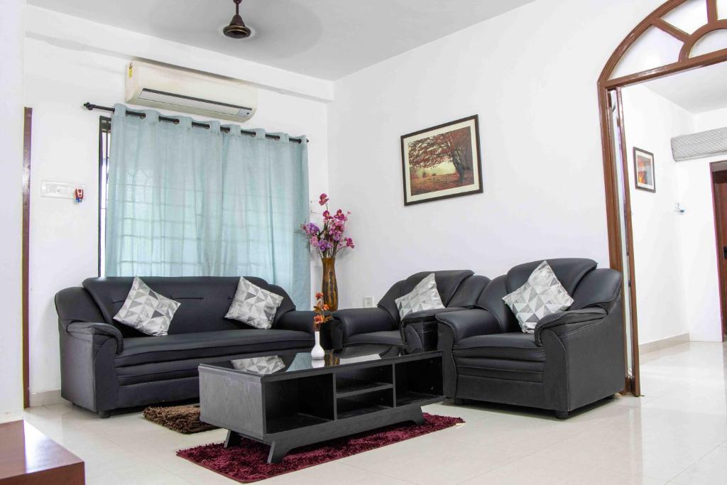 a living room with two couches and a table at Greams Road Near - Apollo - Fusion Serviced Apartments in Chennai