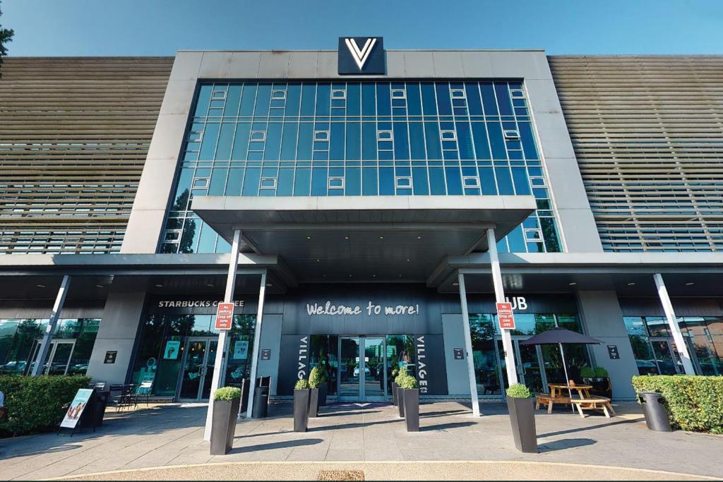 a building with a v sign on top of it at Village Hotel London Watford in Elstree