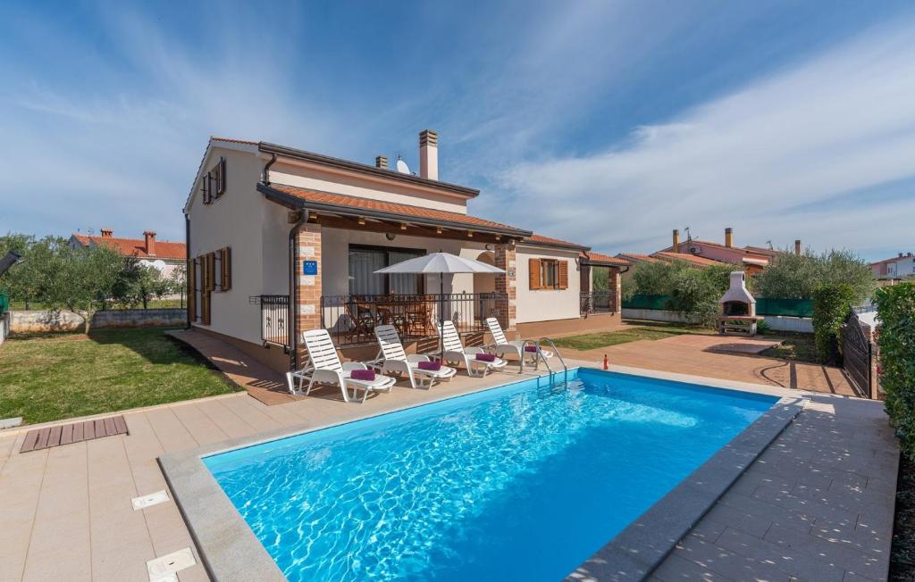 a swimming pool in front of a house at Villa Leonie with Private Pool in Nova Vas