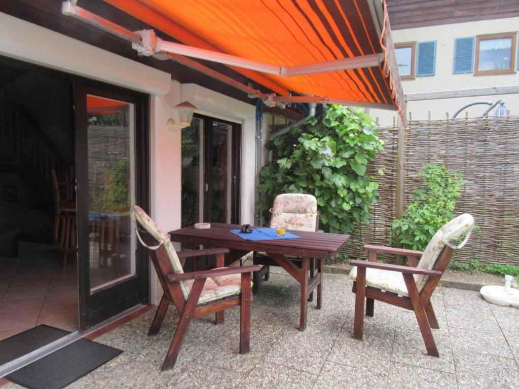 a wooden table and chairs on a patio at Steffl Martina in Grassau