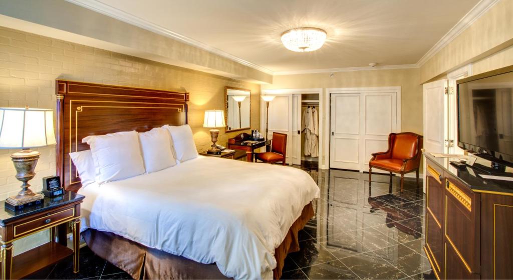 a hotel room with a bed and a television at Hotel Mazarin in New Orleans