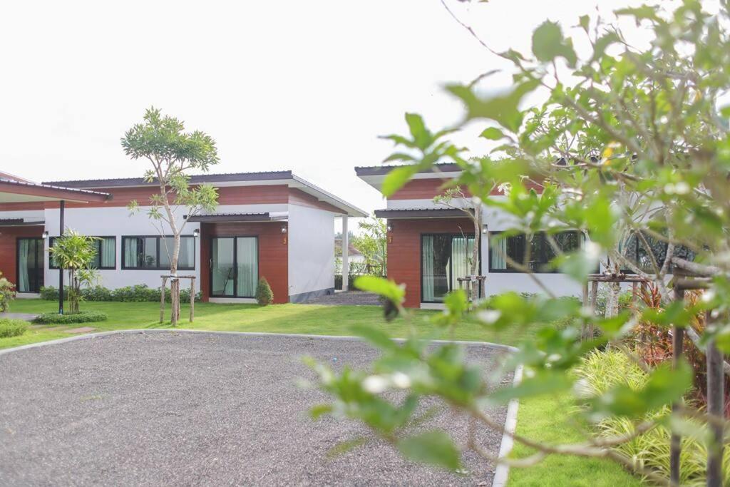 a house with a gravel driveway in front of it at Chill Home Pool Villa Khao Lak in Khao Lak