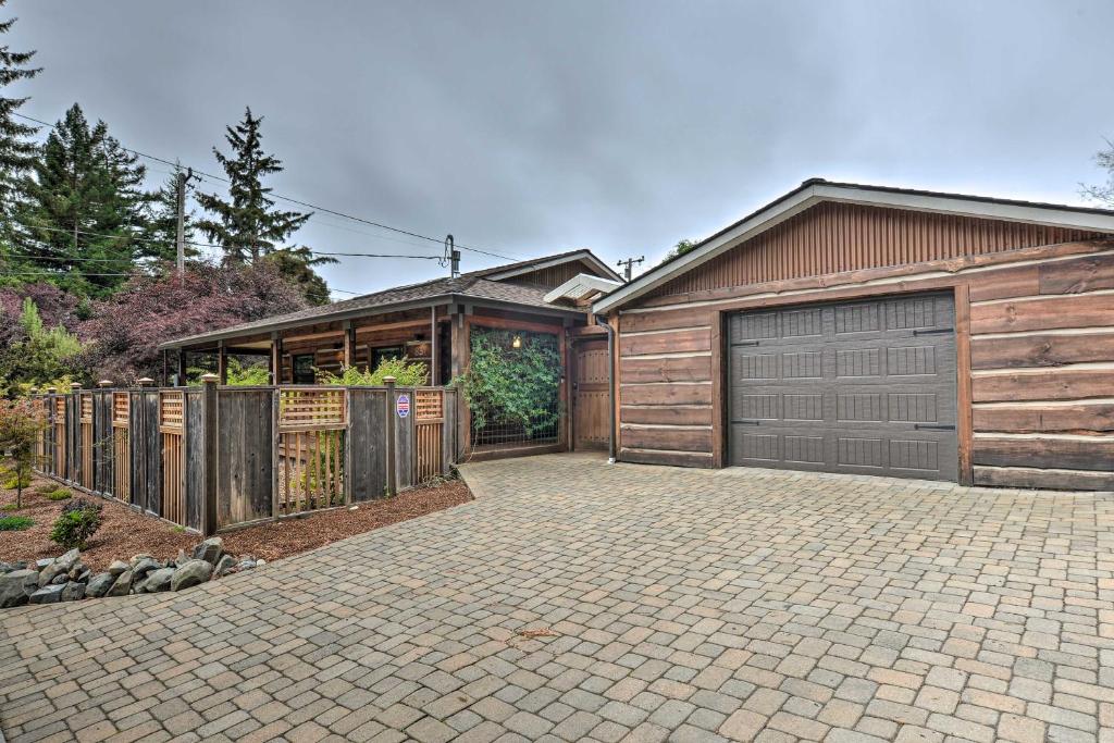a house with a garage and a fence at Quiet and Cozy Eureka Home Near Sequoia Park and Zoo! in Eureka