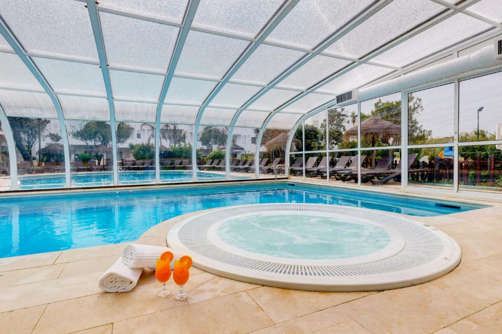 a large swimming pool with a large swimming poolvisor at Duna Parque Beach Club - Duna Parque Group in Vila Nova de Milfontes
