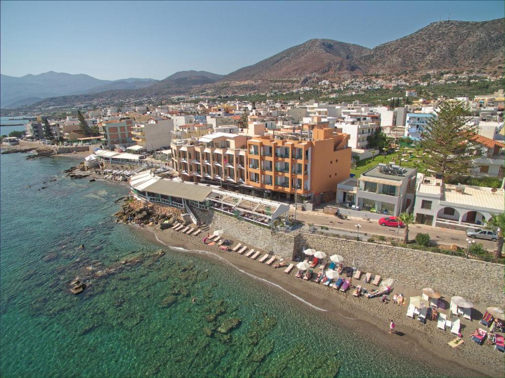 a large body of water with houses and buildings at Palmera Beach Hotel & Spa - Adults Only in Hersonissos
