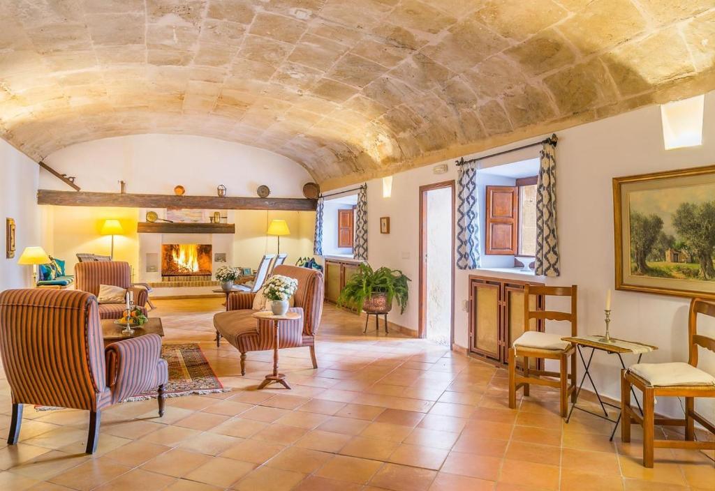 a large living room with a stone ceiling at Historica house with Pool free wifi in Andratx