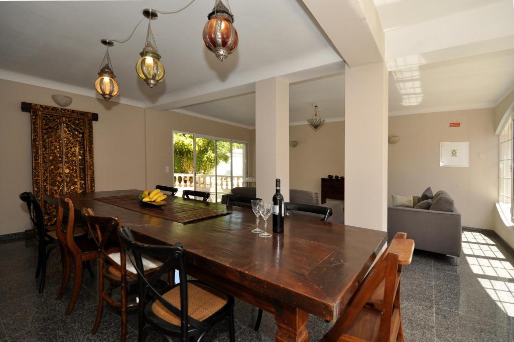 a dining room with a wooden table and chairs at Beachhouselagos in Lagos