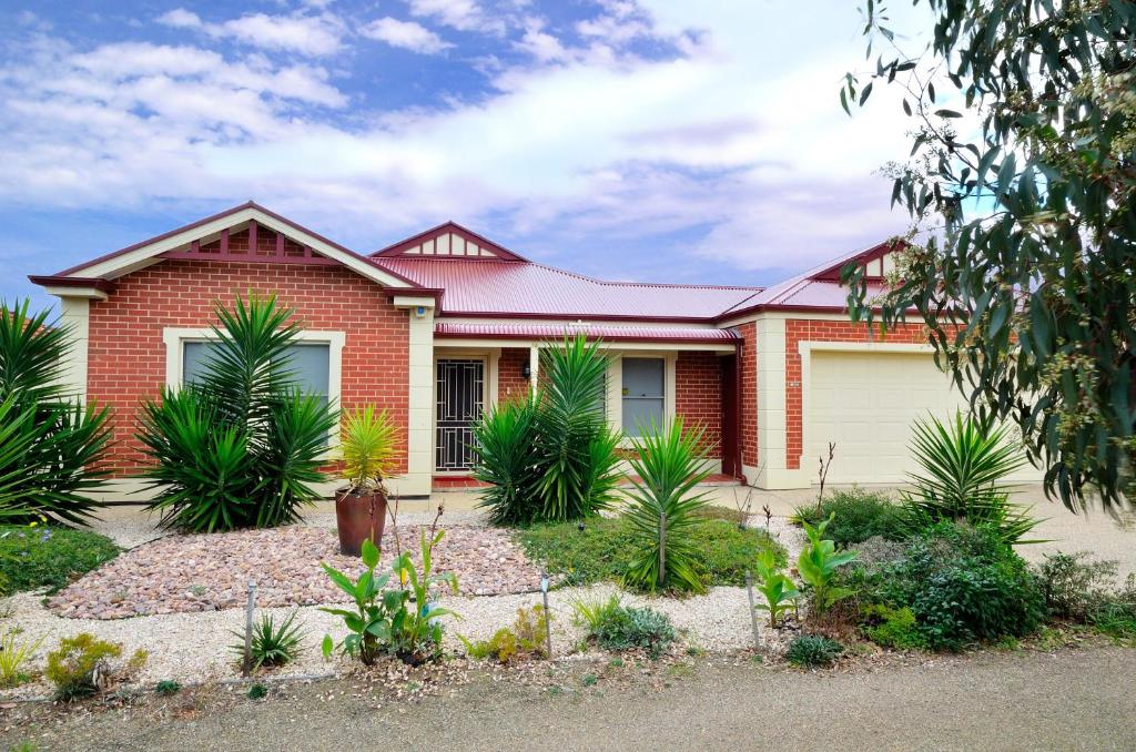 a red brick house with plants in front of it at All Seasons Port Elliot Holiday House in Port Elliot