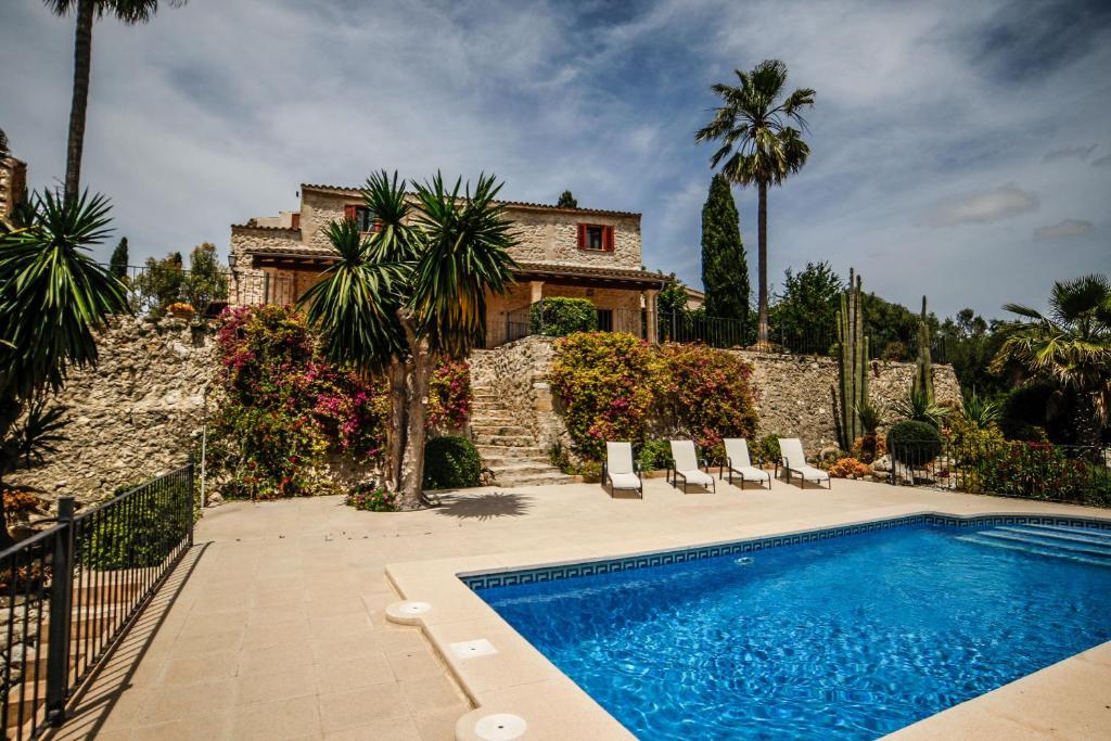 a house with a swimming pool in front of a house at Finca Rural Son Rabassa in Sant Joan