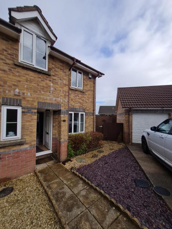 a house with a car parked in front of it at 3 Bed House with Garage, NR BPW & Brecon Beacons National Park in Cefn-coed-y-cymmer