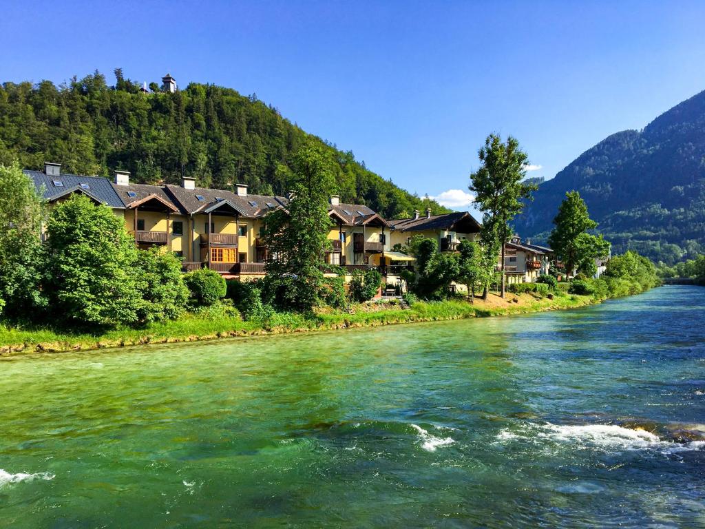 a river with houses on the side of a mountain at Haus Traun-Ufer in Bad Ischl