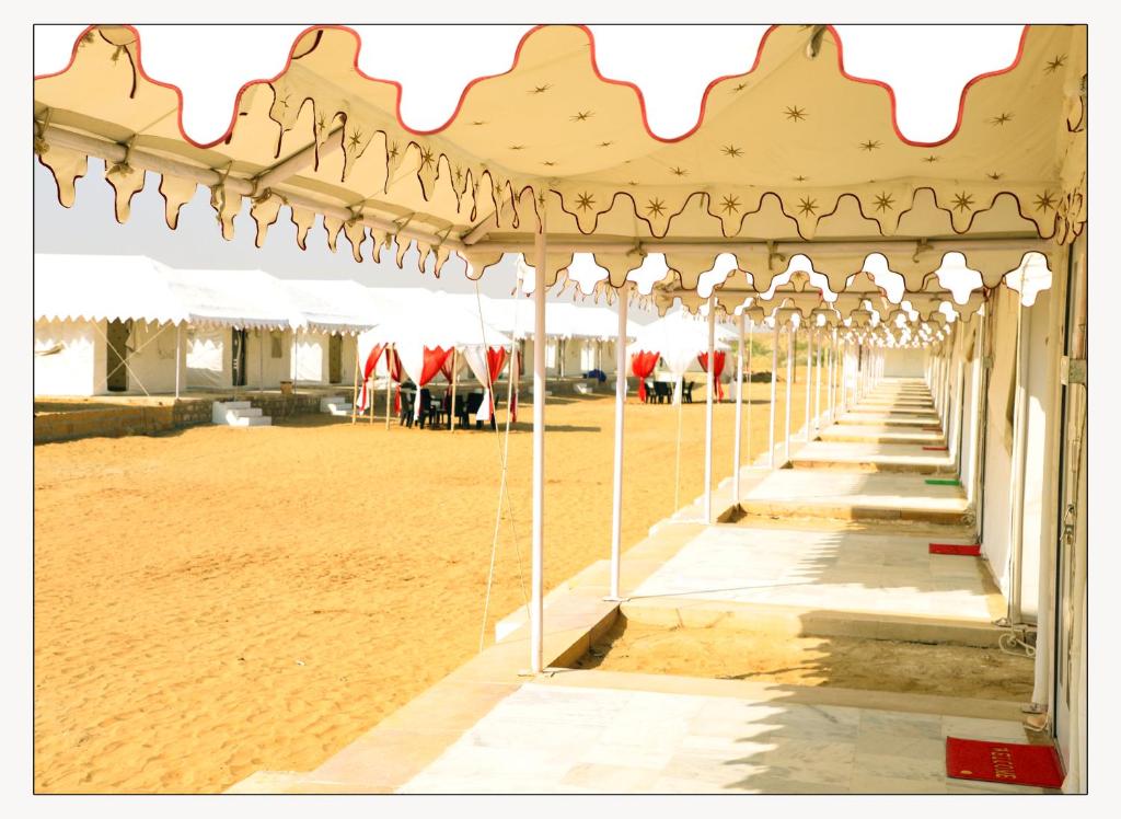 a large pavilion with a beach in the background at Jaisalmer Desert Resort in Jaisalmer