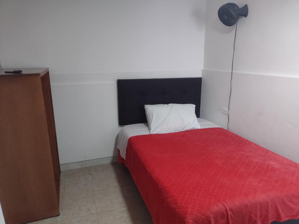 Postel nebo postele na pokoji v ubytování Hotel Risaralda