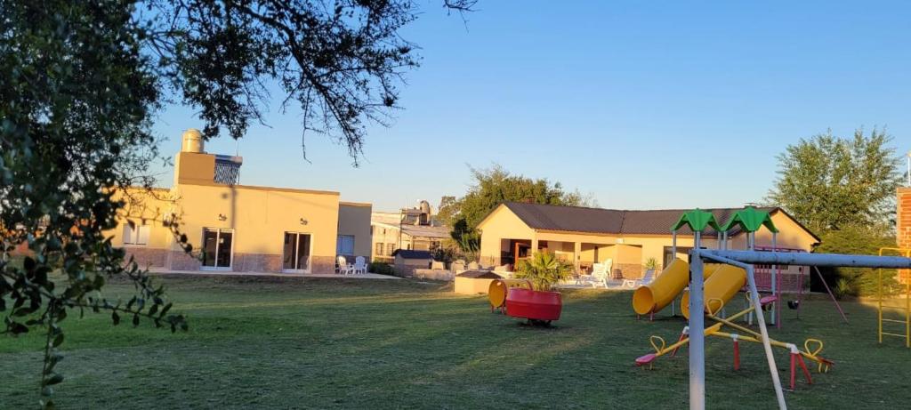 a yard with a playground and a house at El Coronillo - Lodge in Concepción del Uruguay