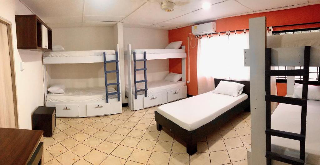 a room with two bunk beds and a window at La Quinta Bacana La Campiña in Barranquilla